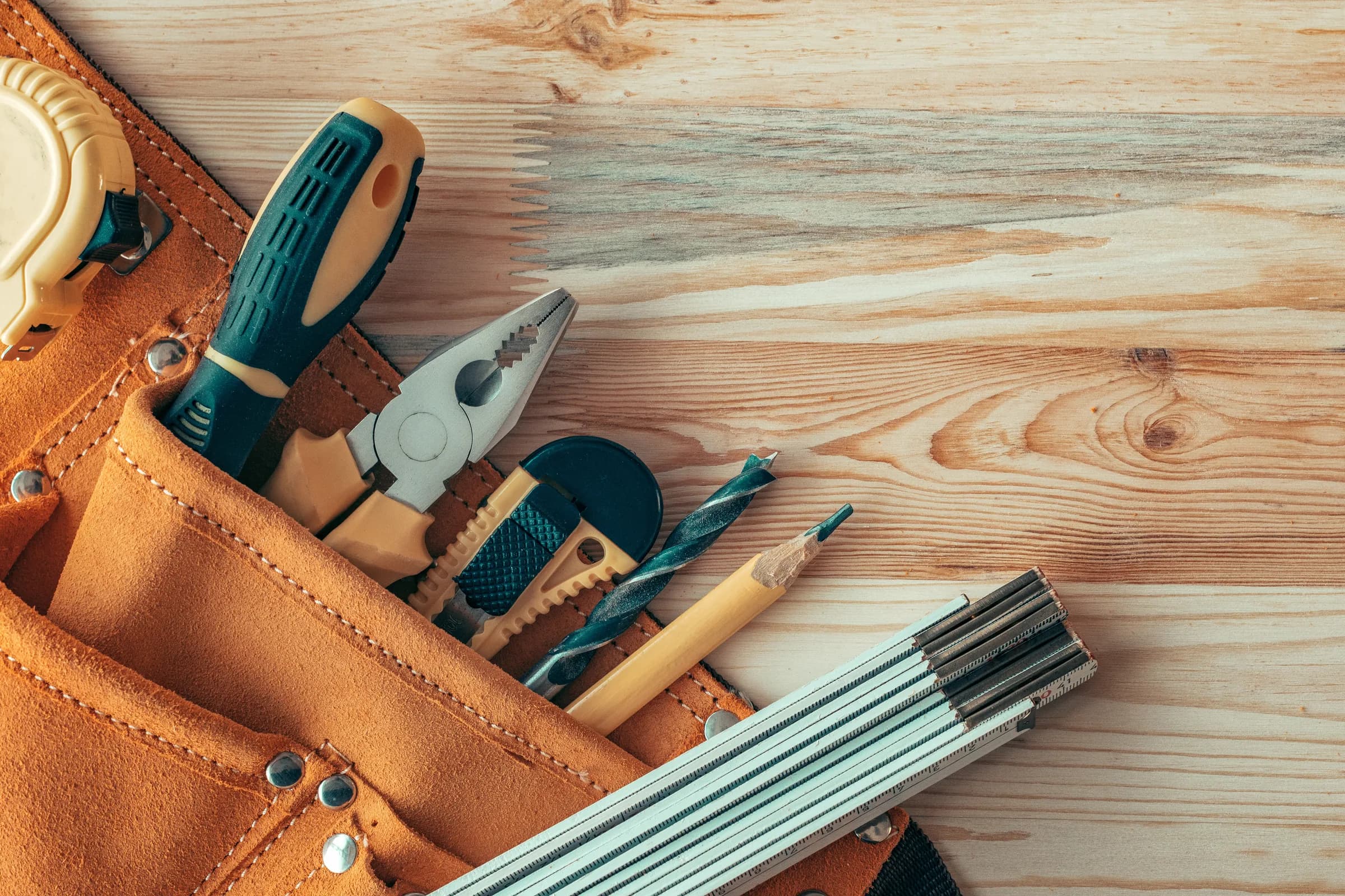 Carpenter's tool belt on a woodwork workshop desk
