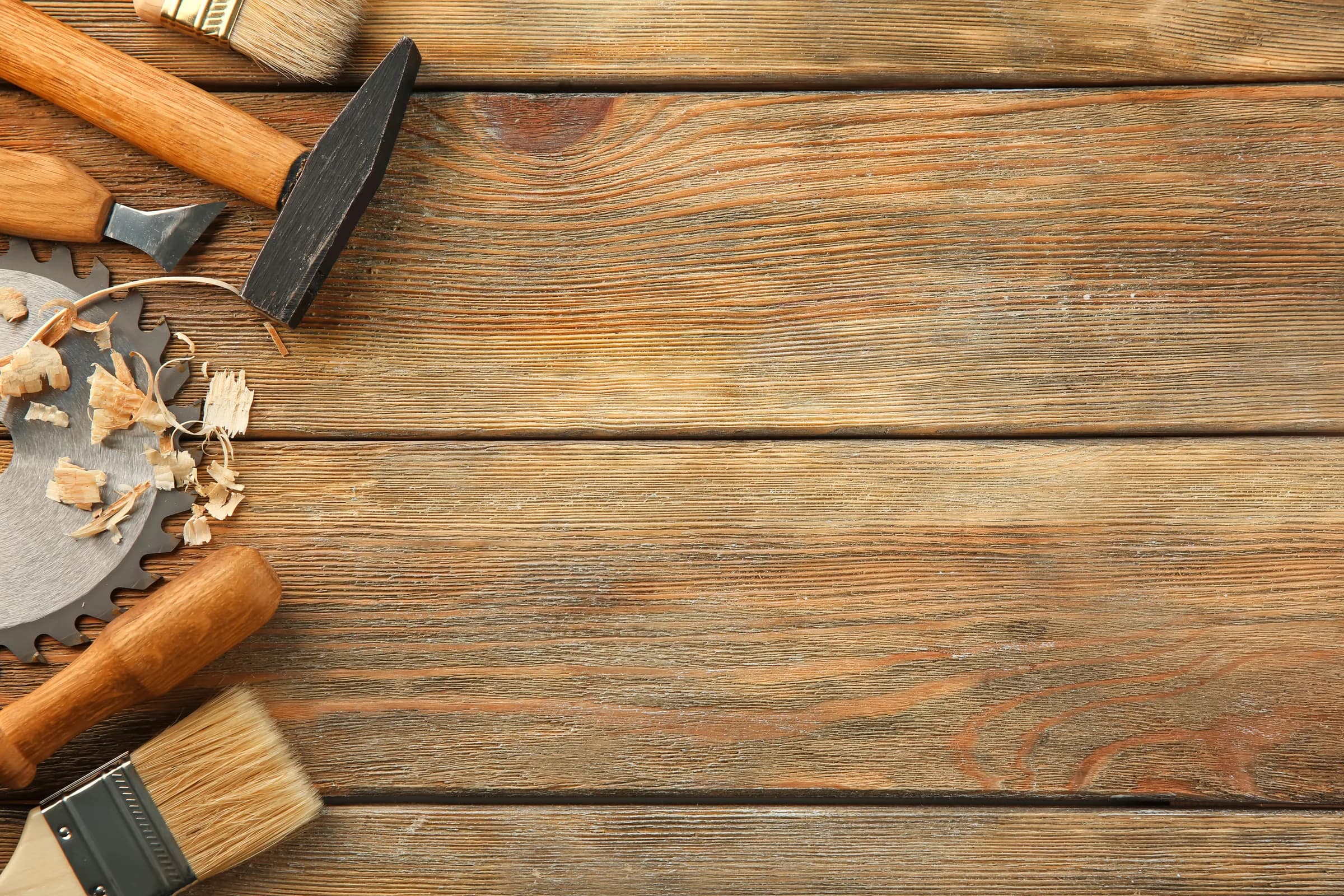 Maker's tools laid out on a wooden workbench