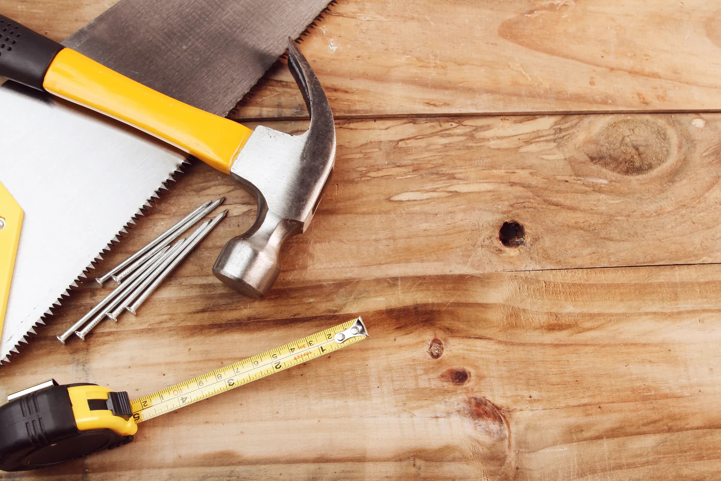 Tools laid across a rough-hewn wood bench